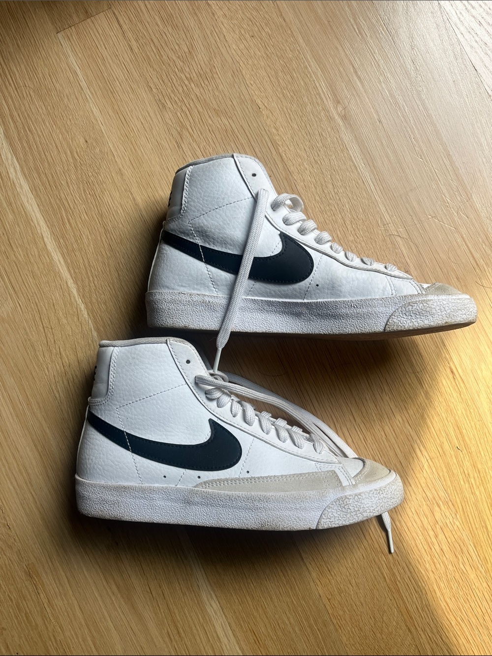 Nike High-Top Sneakers in White with Black Swoosh